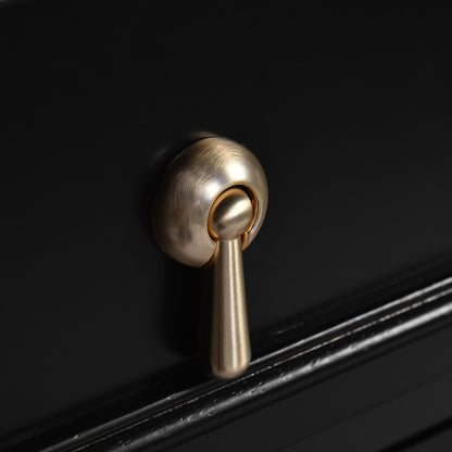 Detail of teardrop handles on a 20 black mid century modern freestanding dresser