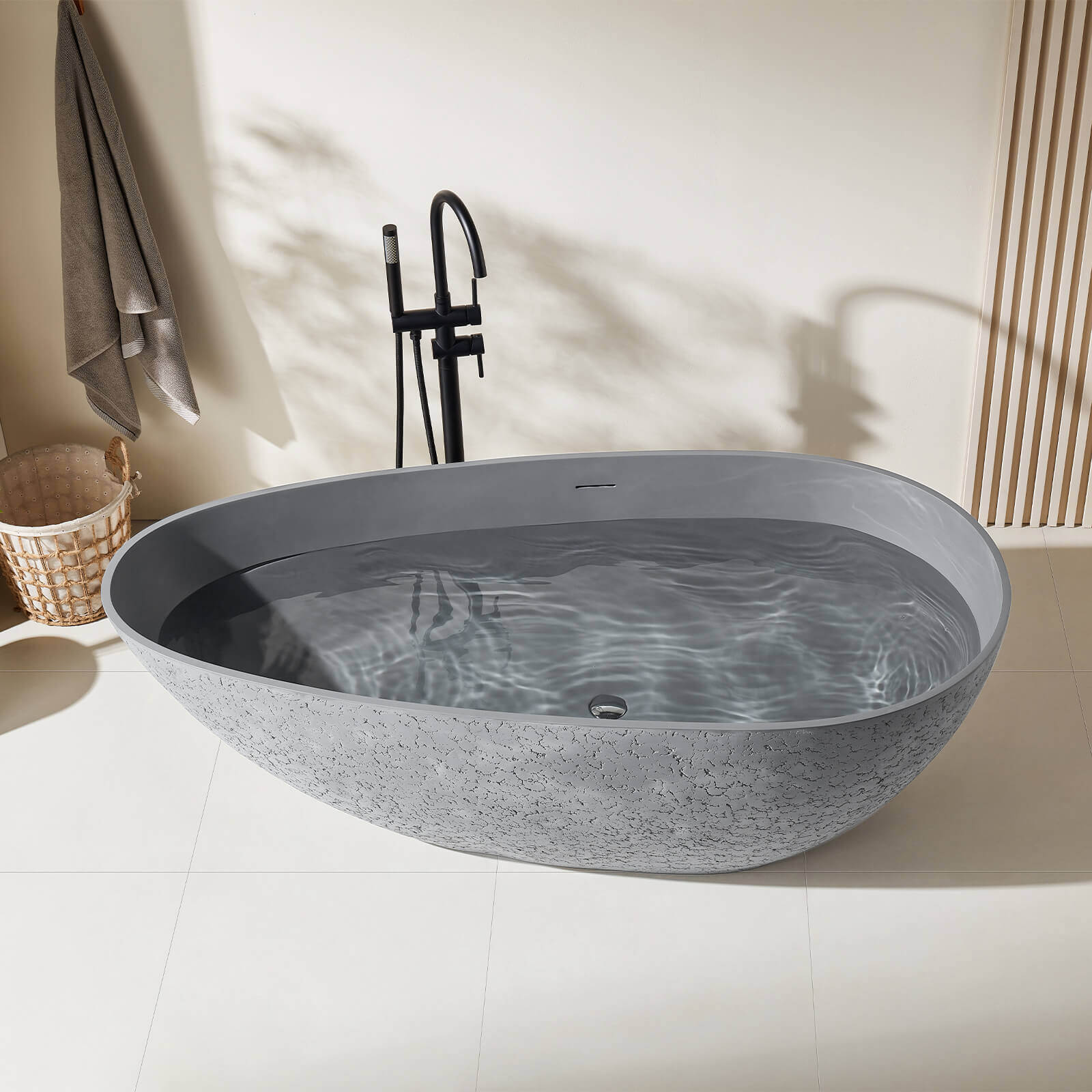 Freestanding industrial style bathtub in textured concrete gray