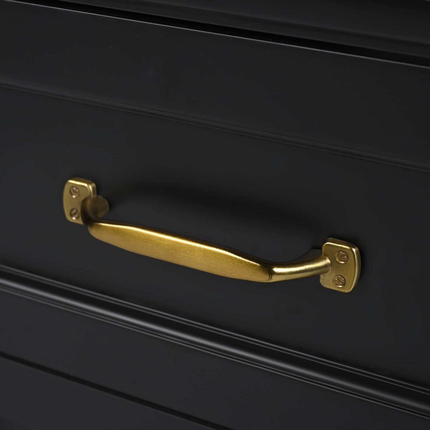 Gold handles on 30 in black acacia dresser with bottom drawer