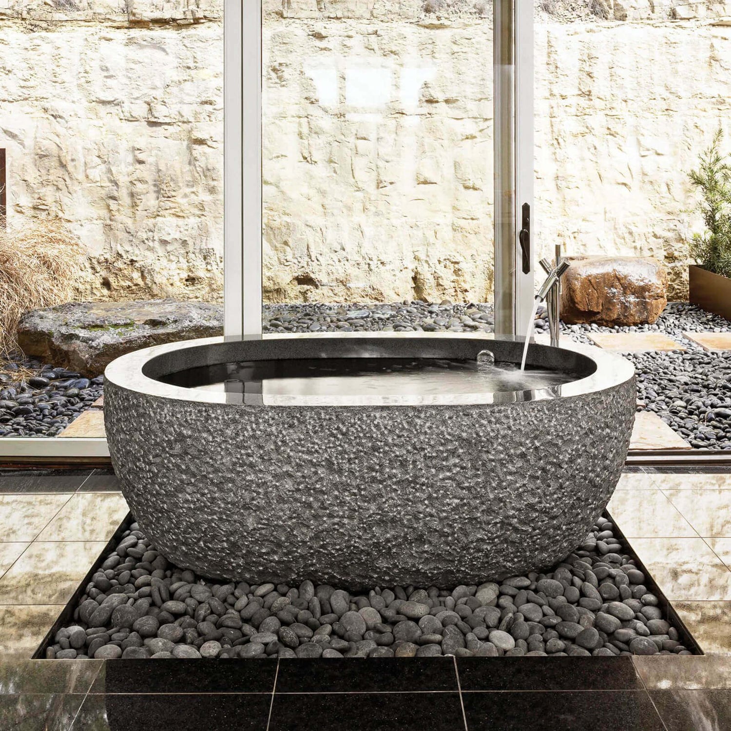 Oval stone bathtub with artistic pattern